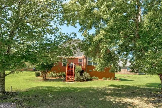 a view of a garden with a house