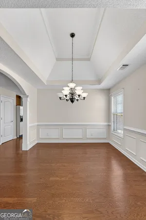 a view of a room with a fireplace and wooden floor