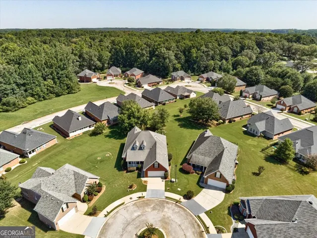 an aerial view of a house with outdoor space patio and swimming pool