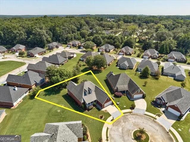 an aerial view of residential houses with outdoor space