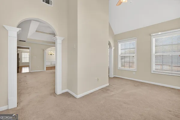 an empty room with windows and closet