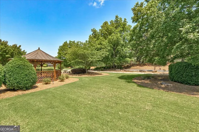 a view of a barn with a large tree