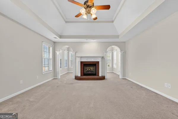 a view of an empty room with a window and closet
