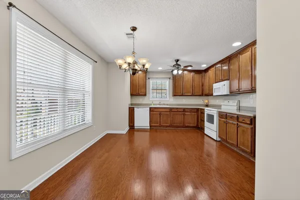 a kitchen with stainless steel appliances a sink and cabinets