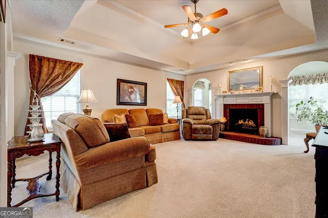 a view of a livingroom with furniture wooden floor a chandelier