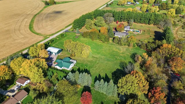 a front view of a house with a yard and trees