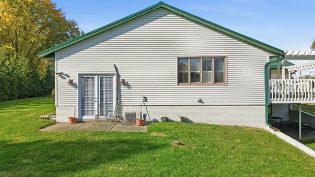a spacious bedroom with a bed and a chandelier