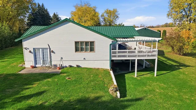 a view of a house with a yard and sitting area