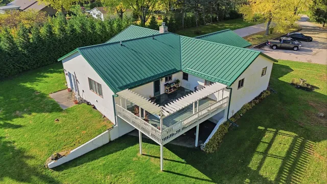 an aerial view of a residential houses with outdoor space