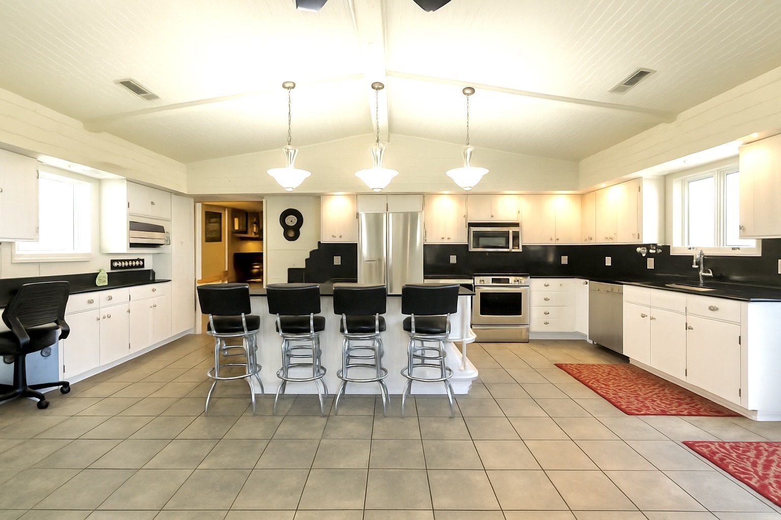1764 Wolverine Road Dixon, IL 61021 - Photo 71 of 86 a large white kitchen with a large window and stainless steel appliances