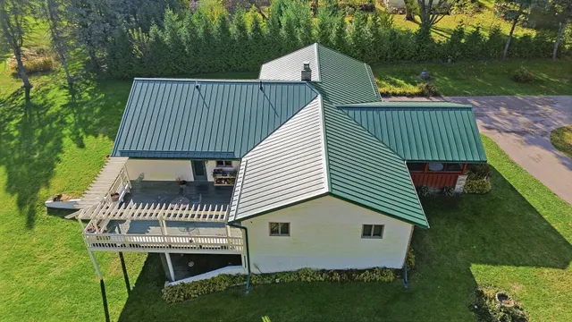 an aerial view of a house with a yard basket ball court and outdoor seating