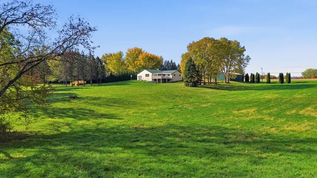 a view of a house with wooden fence