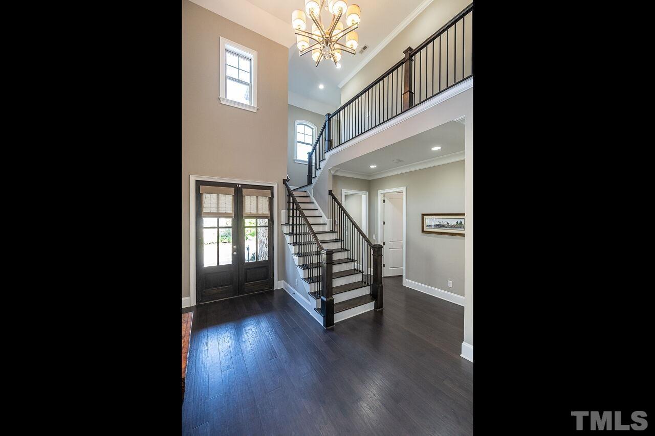 3706 Rolston Drive Raleigh, NC 27609 - Photo 3 of 46 a view of an entryway with wooden floor and stairs