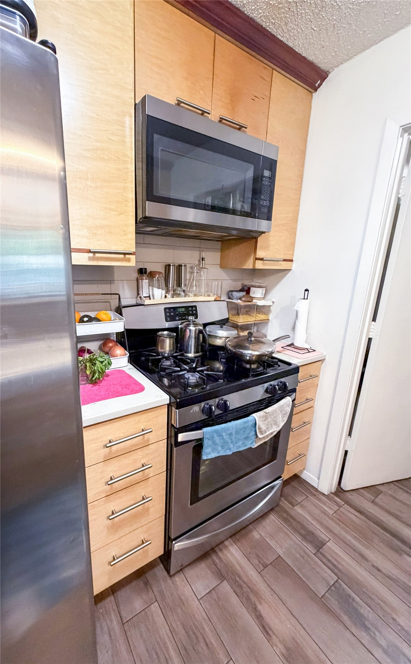 911 Kirschner Place, Unit A Austin, TX 78758 - Photo 5 of 12 Stainless steel appliances and ample cabinetry create a functional, modern culinary space.