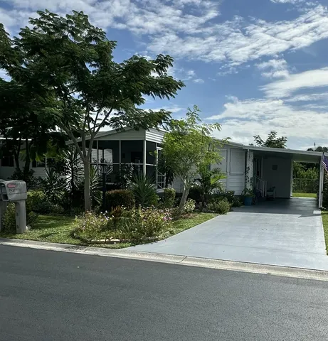 a front view of house with a garden