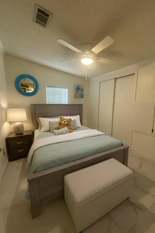 a bedroom with a bed and a lamp