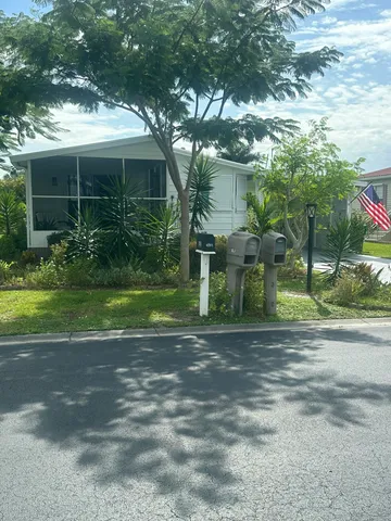 a view of a house with yard and green space