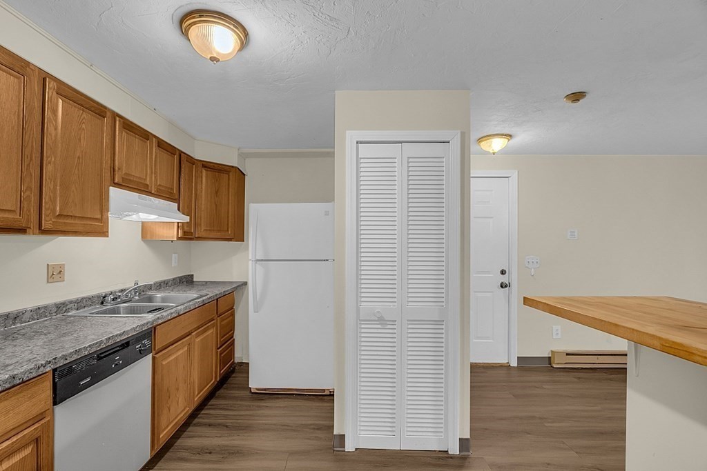 11 Gibbs Street, Unit A6 Worcester, MA 01607 - Photo 15 of 26 a kitchen with stainless steel appliances granite countertop a stove a sink and a refrigerator