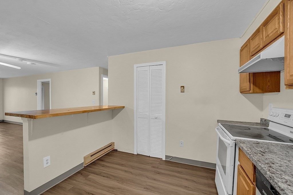 11 Gibbs Street, Unit A6 Worcester, MA 01607 - Photo 16 of 26 a kitchen with granite countertop a sink and a stove top oven