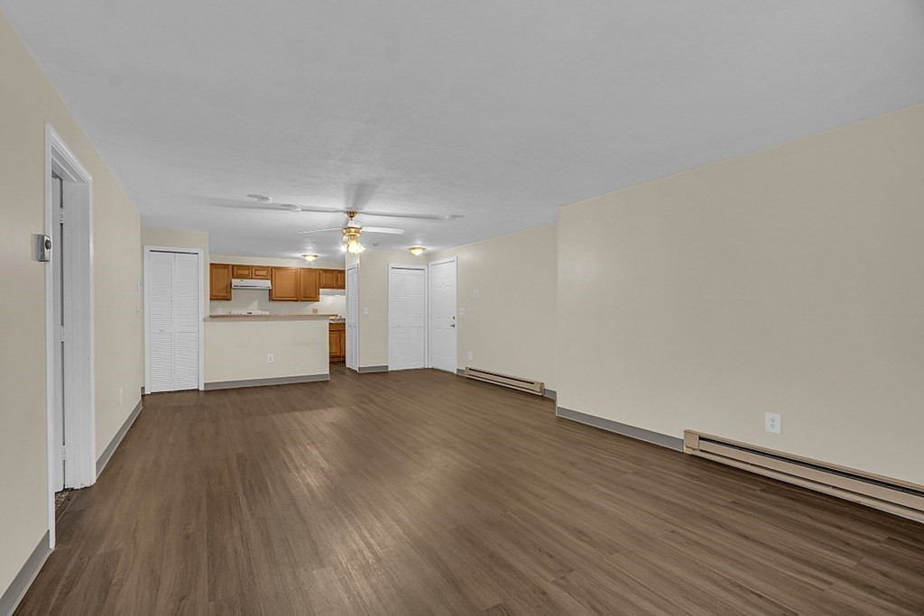 11 Gibbs Street, Unit A6 Worcester, MA 01607 - Photo 21 of 26 wooden floor in an empty room with a kitchen