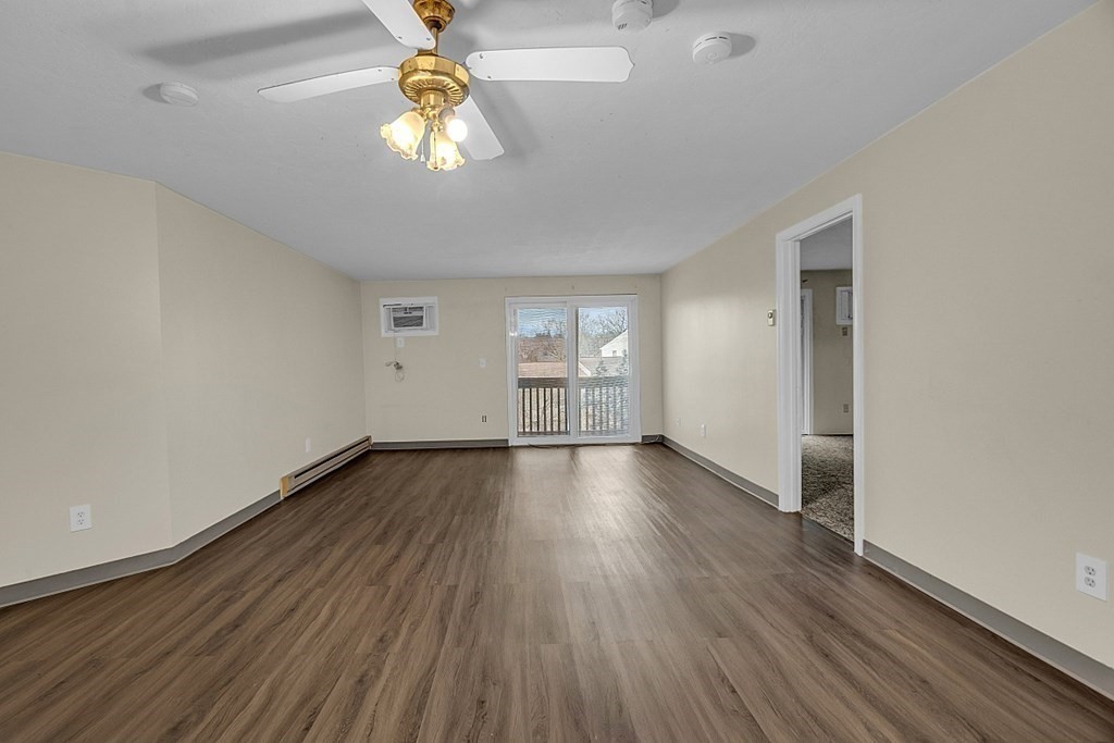 11 Gibbs Street, Unit A6 Worcester, MA 01607 - Photo 22 of 26 an empty room with wooden floor and windows