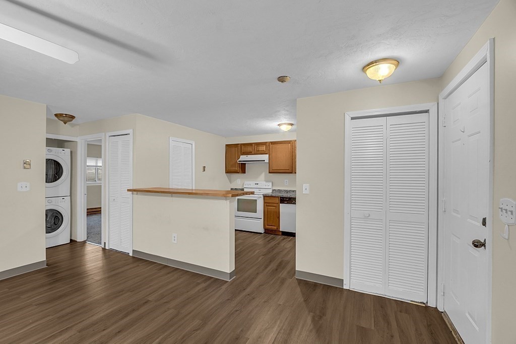 11 Gibbs Street, Unit A6 Worcester, MA 01607 - Photo 7 of 26 a view of a kitchen with a refrigerator wooden floor and a window