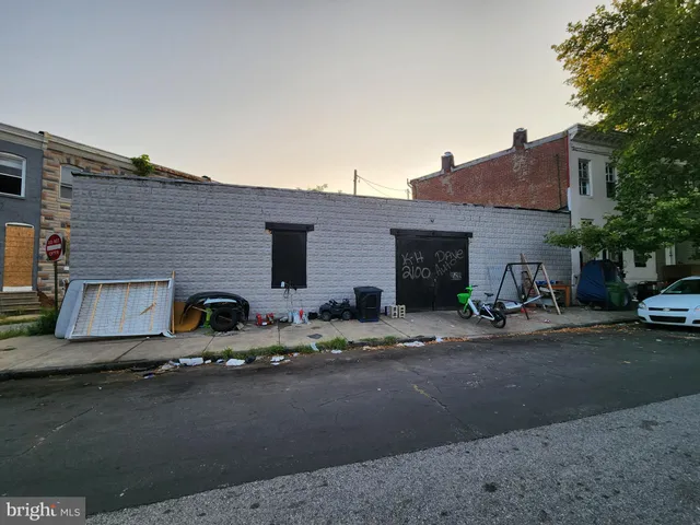 a couple of cars parked in front of a house