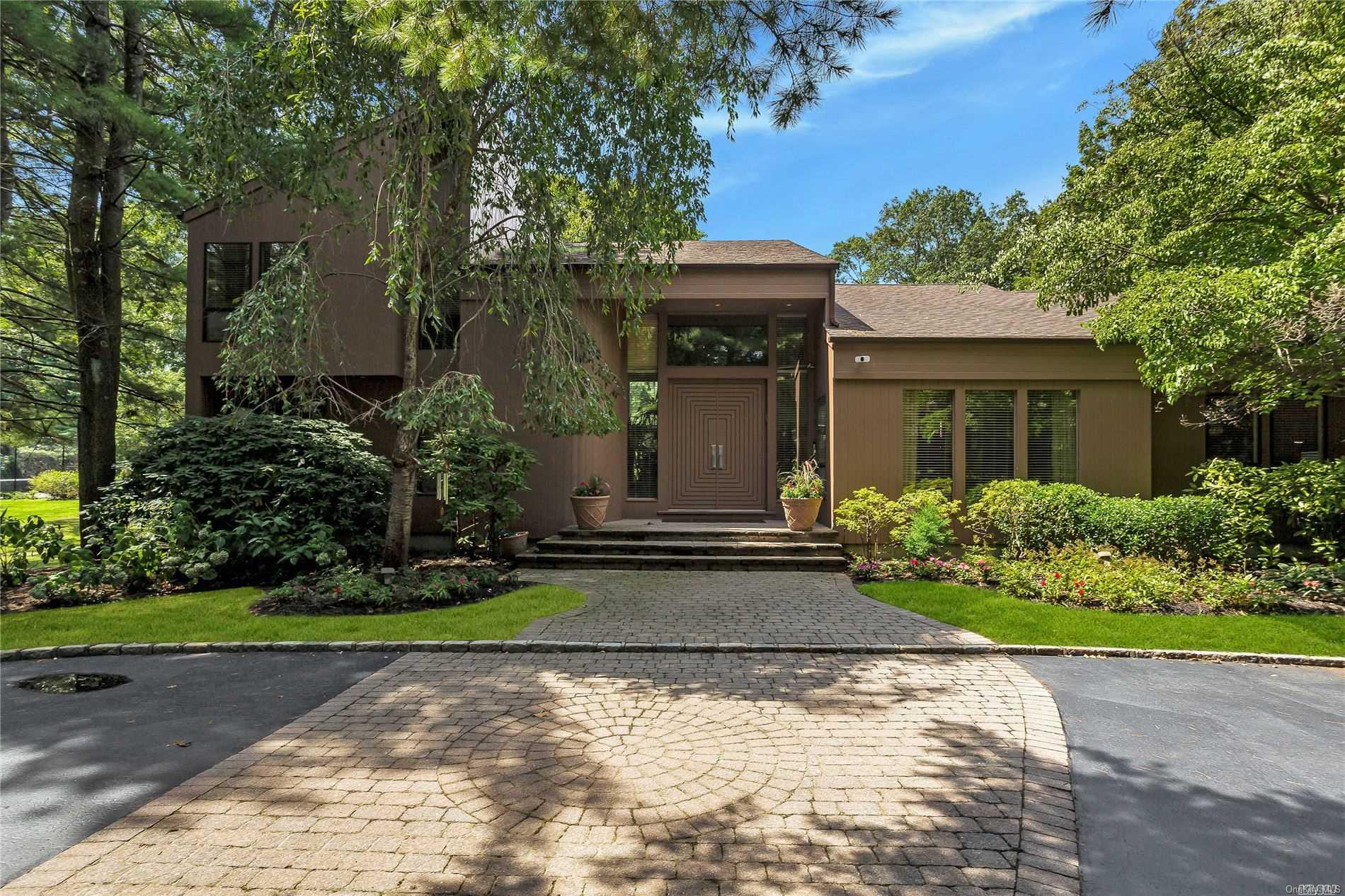 100 Rodeo Drive Syosset, NY 11791 - Photo 1 of 1 a front view of a house with garden