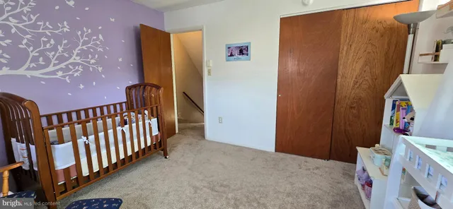 a bed sitting in a bedroom next to a window