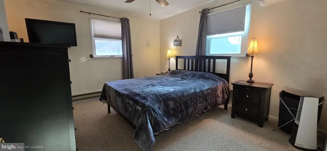 a bedroom with a bed and a large mirror