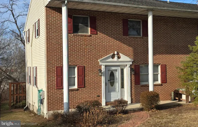 a view of a house with brick walls