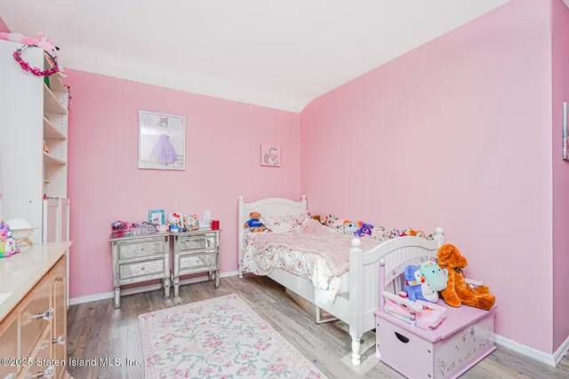 a bed room with a bed and a painting on the wall