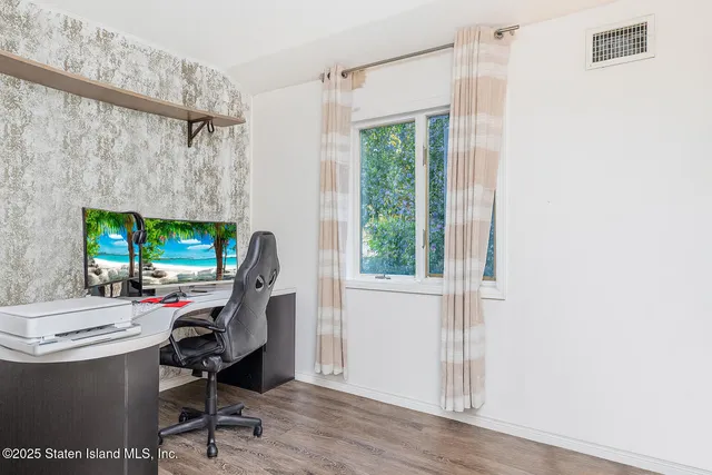 a view of a kitchen with furniture and flat screen tv