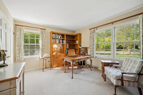 a view of a livingroom with furniture and a large window