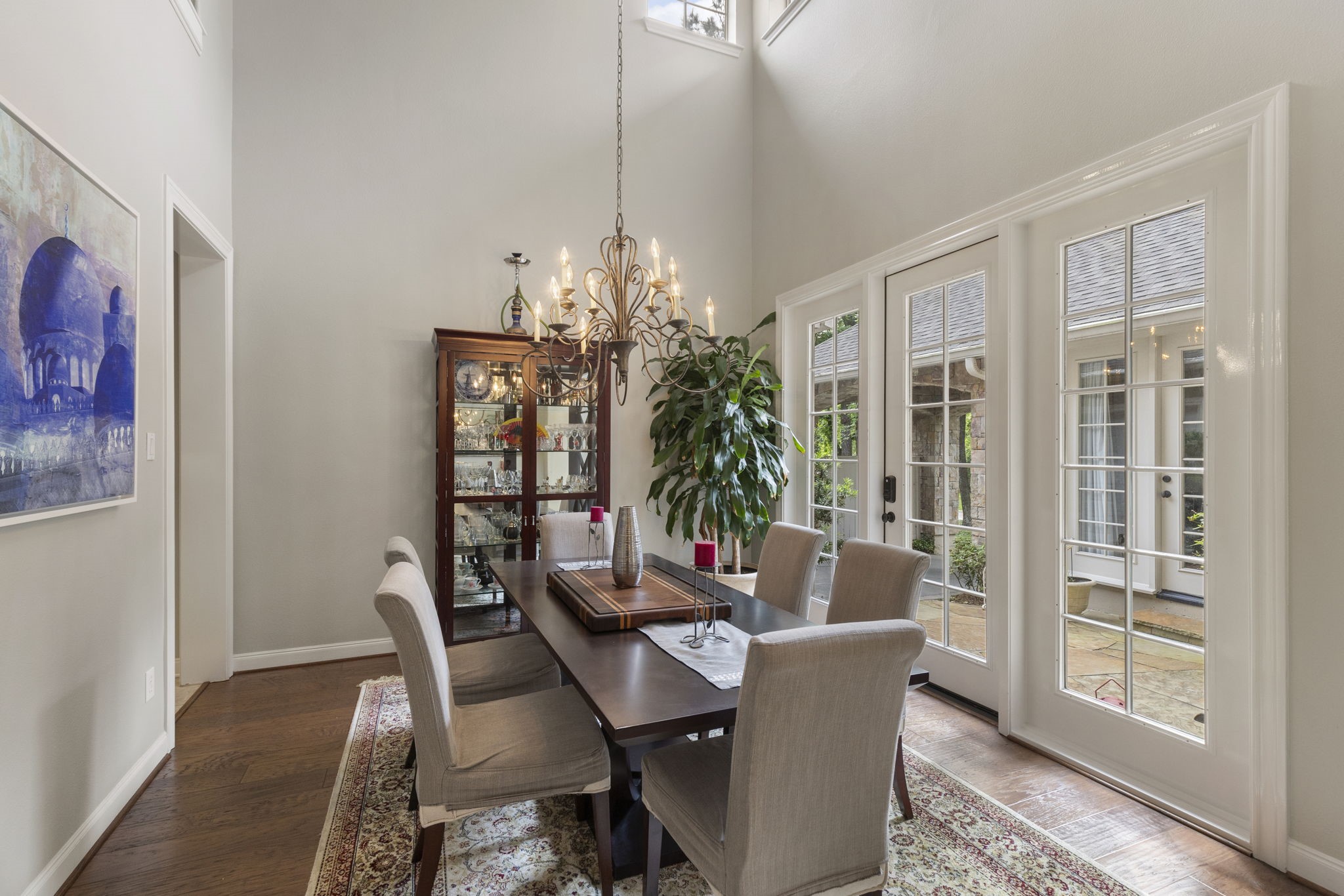 107 East Mirror Ridge Circle The Woodlands, TX 77382 - Photo 14 of 47 a dining room with furniture potted plants and wooden floor