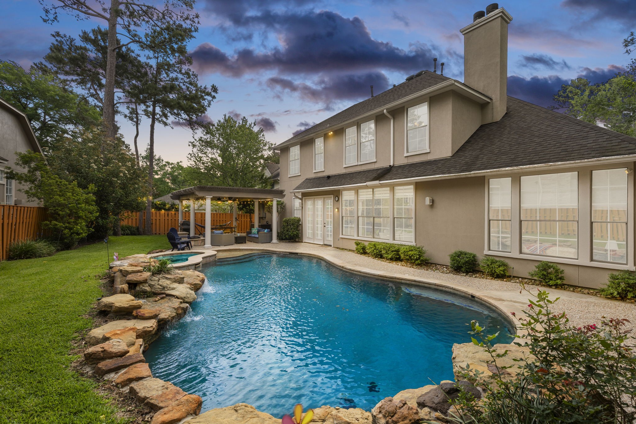 107 East Mirror Ridge Circle The Woodlands, TX 77382 - Photo 2 of 47 a view of a house with swimming pool lawn chairs and a yard