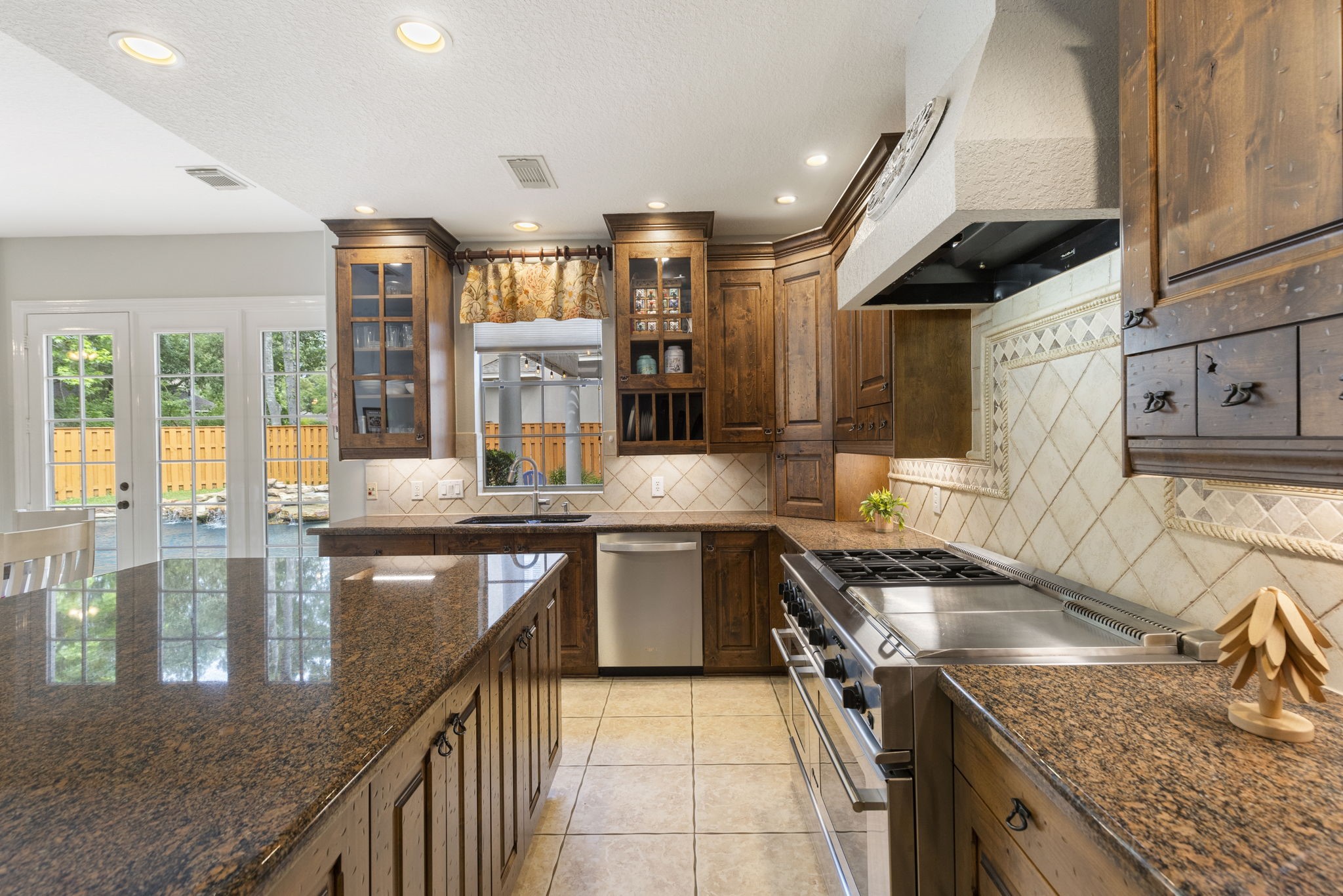 107 East Mirror Ridge Circle The Woodlands, TX 77382 - Photo 23 of 47 a kitchen with a stove sink and cabinets