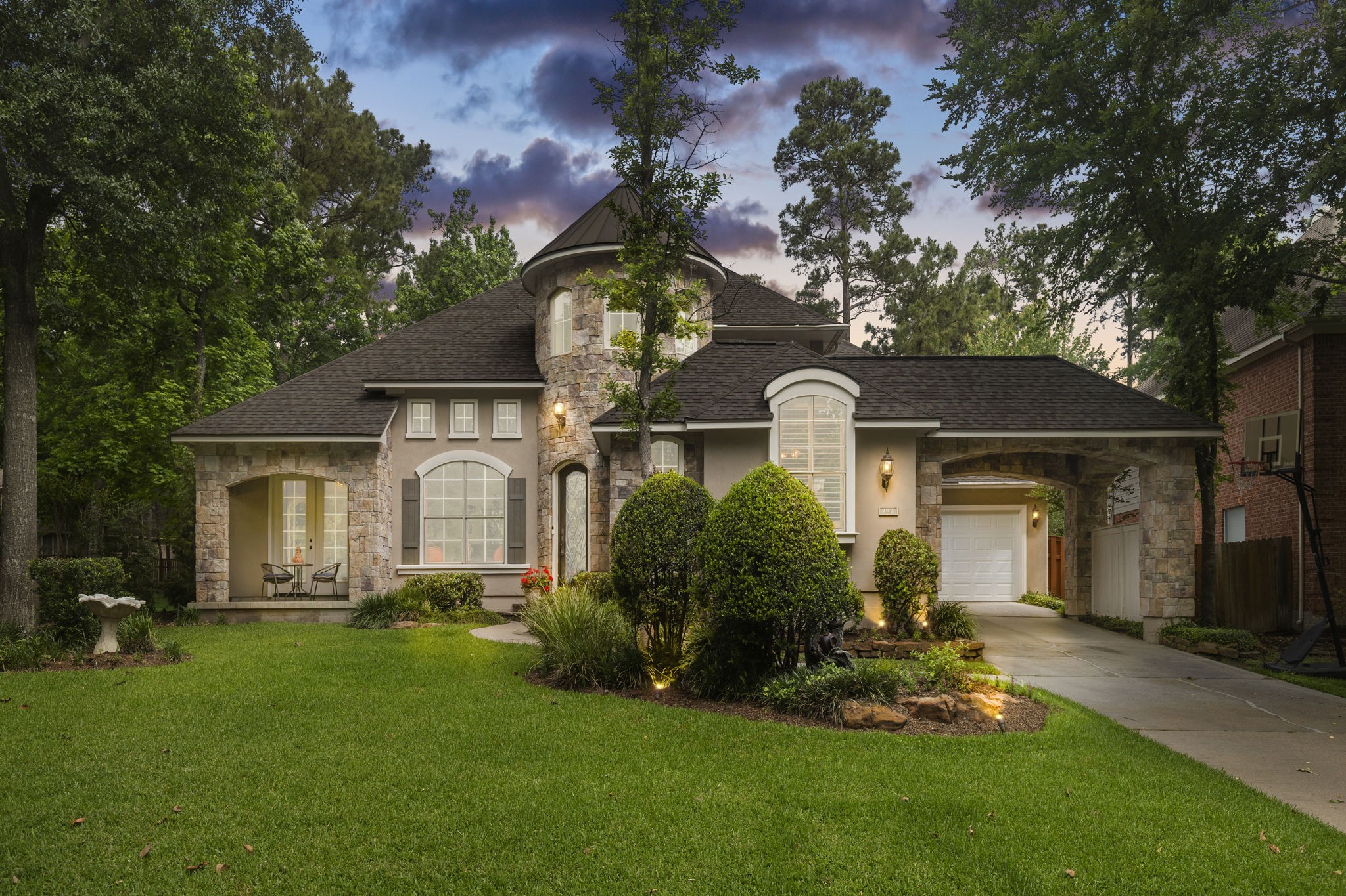 107 East Mirror Ridge Circle The Woodlands, TX 77382 - Photo 46 of 47 a front view of a house with a garden and plants