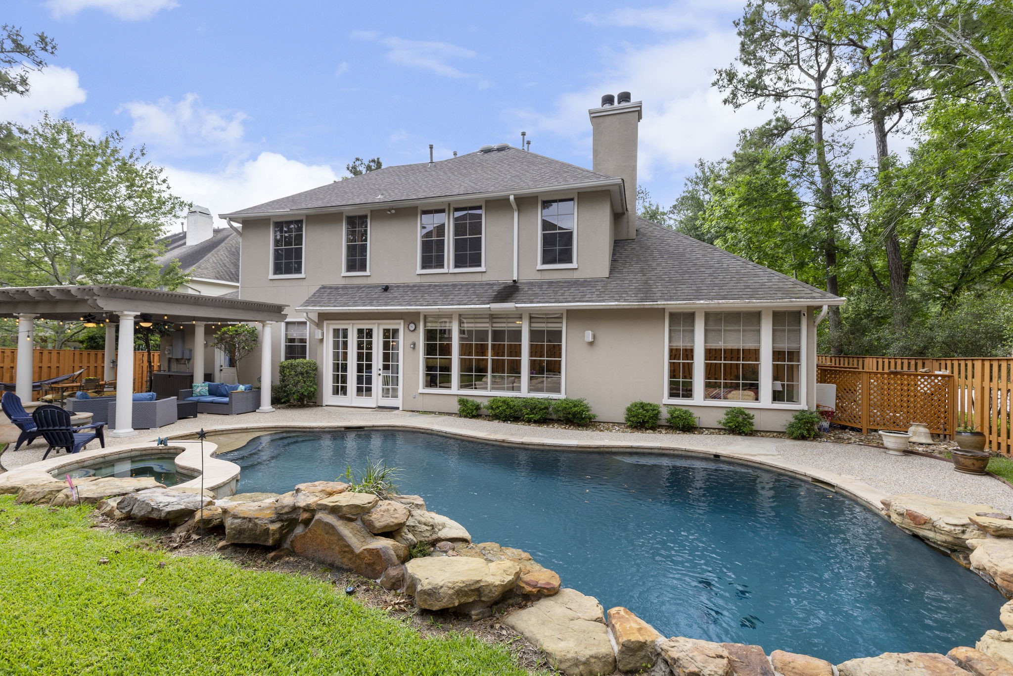 107 East Mirror Ridge Circle The Woodlands, TX 77382 - Photo 5 of 47 a front view of a house with swimming pool and furniture