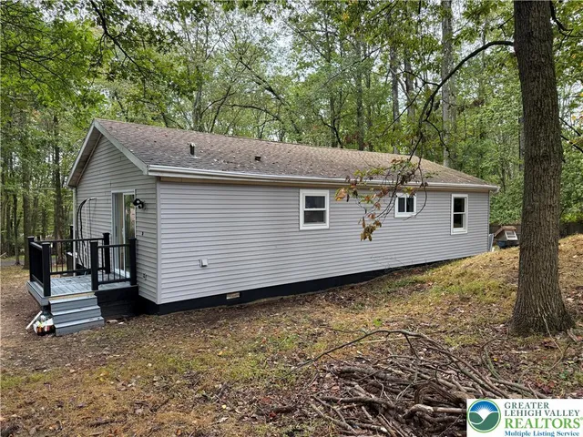 a view of a house with a backyard