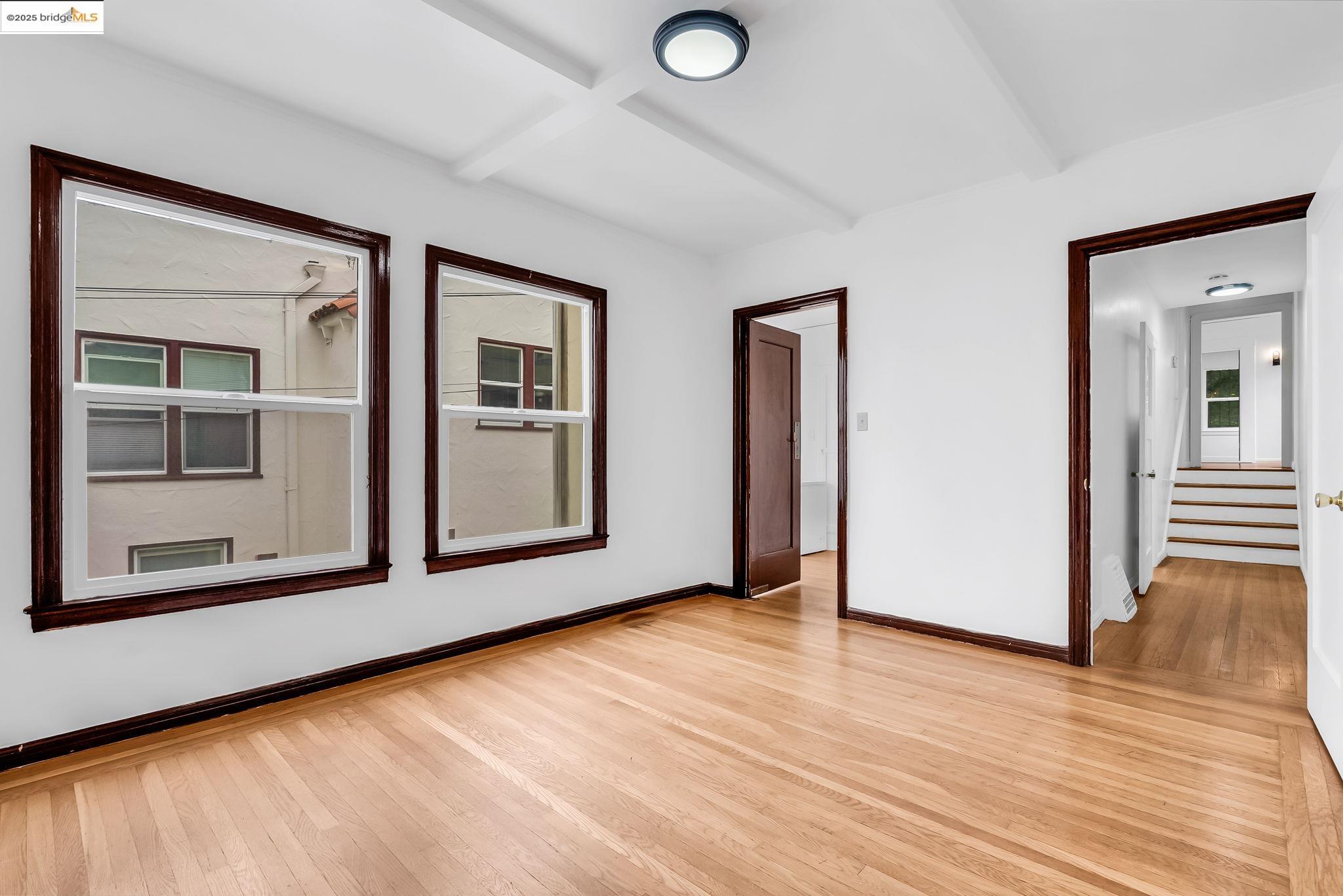 2340 Virginia Street Berkeley, CA 94709 - Photo 12 of 56 a view of an empty room with wooden floor and a window