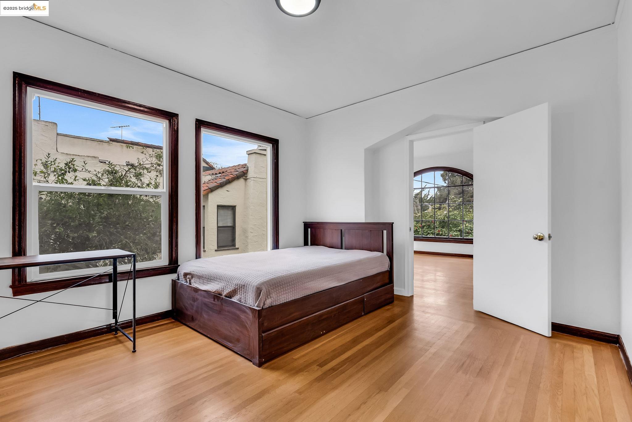 2340 Virginia Street Berkeley, CA 94709 - Photo 18 of 56 a large bedroom with a bed and wooden floor