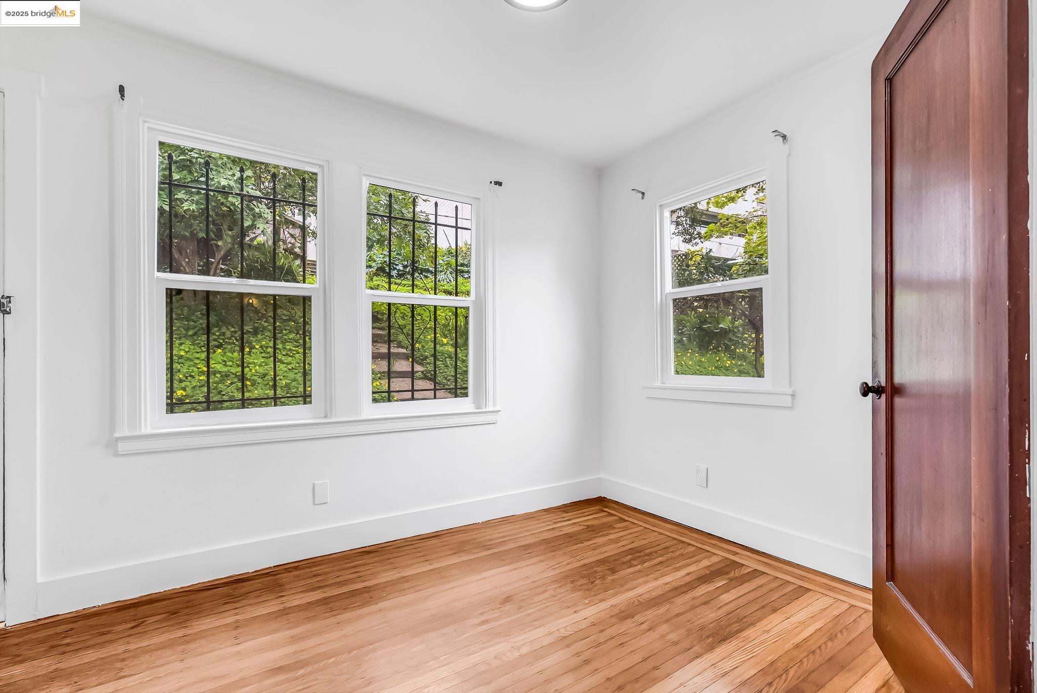 2340 Virginia Street Berkeley, CA 94709 - Photo 22 of 56 a view of an empty room with wooden floor and a window
