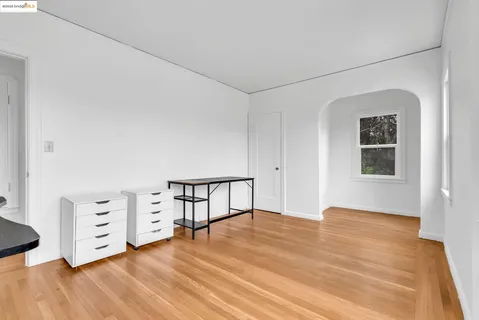 a kitchen with stainless steel appliances a stove a sink and white cabinets