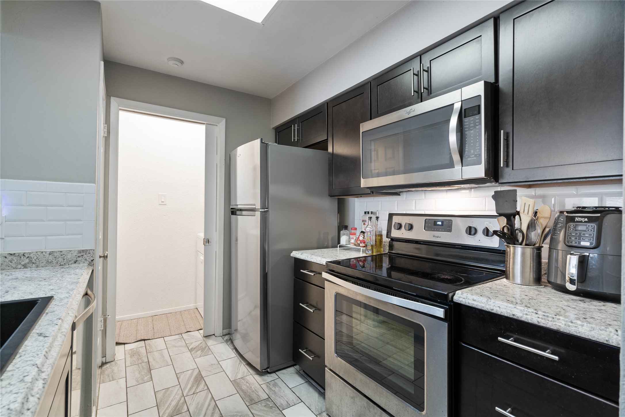 807 West 25th Street, Unit 307 Austin, TX 78705 - Photo 12 of 27 Galley kitchen with stainless steel appliances