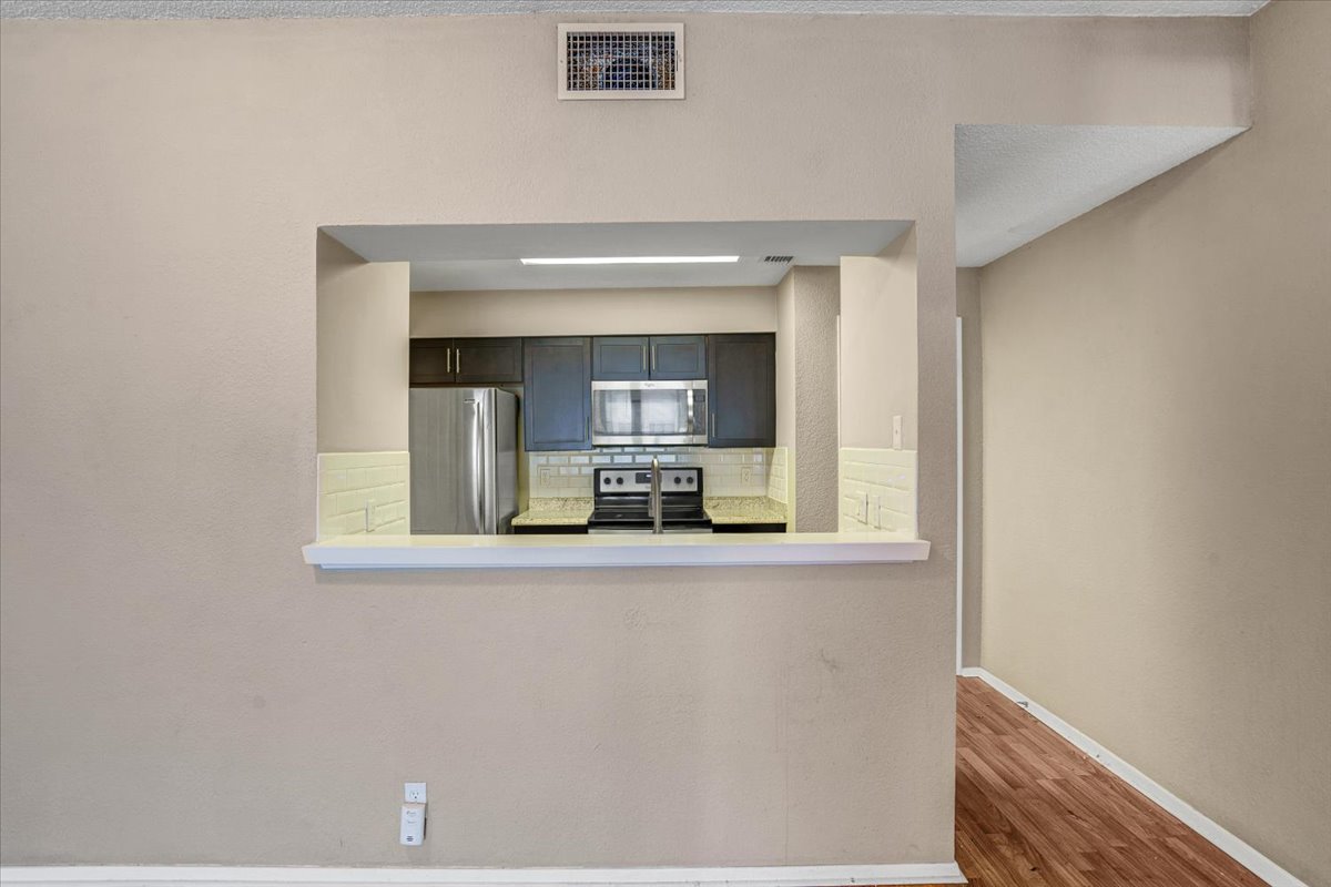 807 West 25th Street, Unit 307 Austin, TX 78705 - Photo 13 of 27 Looking into the kitchen from the dining and living areas