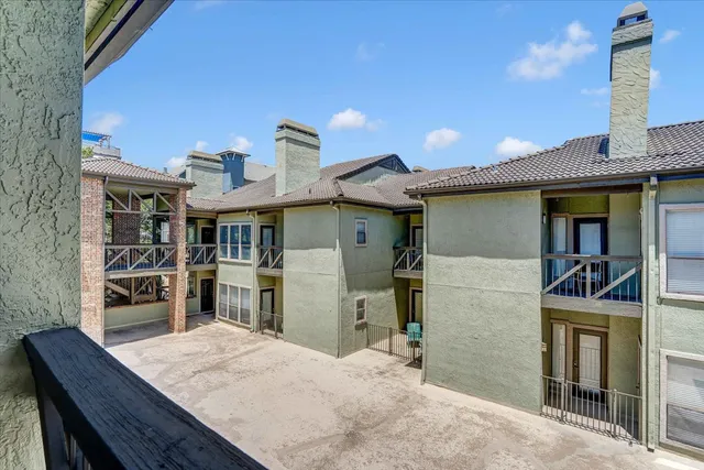 a view of balcony with wooden floor and fence