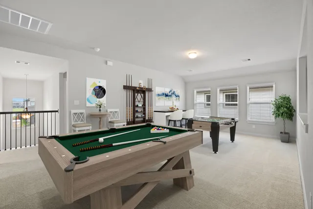 a living room with furniture pool table and a large window