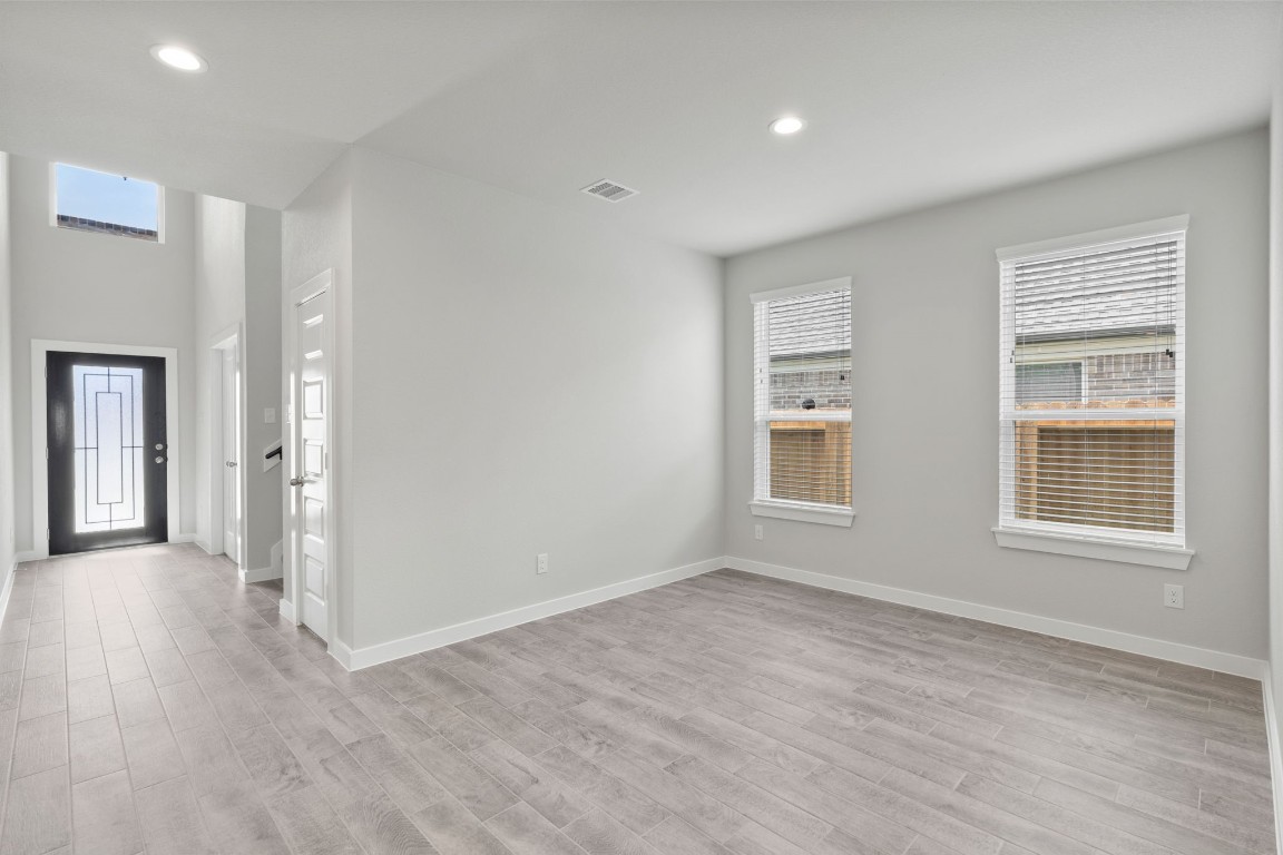 15711 Telge Ridge Lane Cypress, TX 77429 - Photo 4 of 20 a view of an empty room with wooden floor and a window