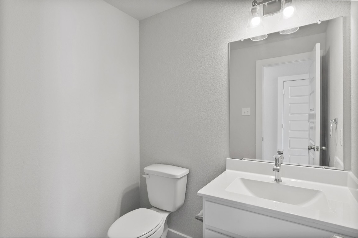 15711 Telge Ridge Lane Cypress, TX 77429 - Photo 5 of 20 a bathroom with a toilet a sink and mirror